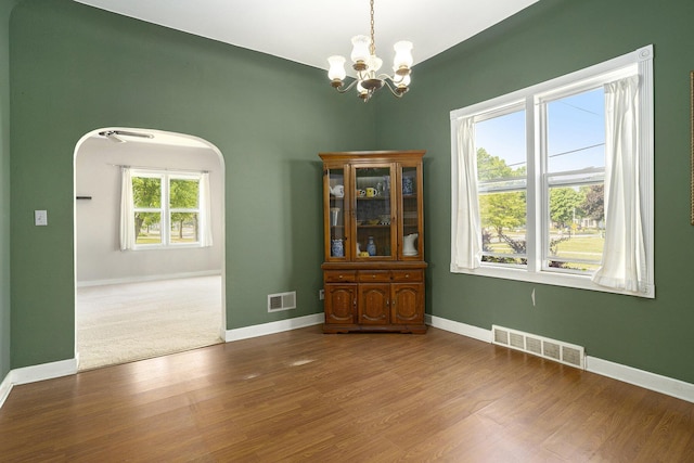 1386 W Broadway Ave, Muskegon, MI 49441 - dining room featuring a chandelier, baseboards, and wood finished floors