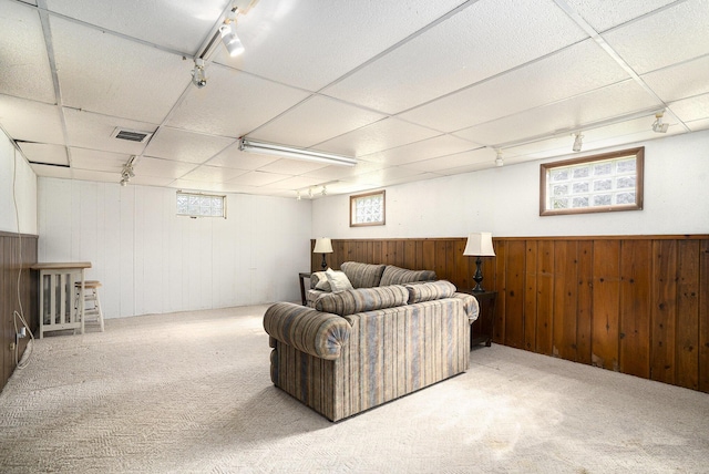1386 W Broadway Ave, Muskegon, MI 49441 - carpeted living room with plenty of natural light, wood walls, a drop ceiling, and a wainscoted wall