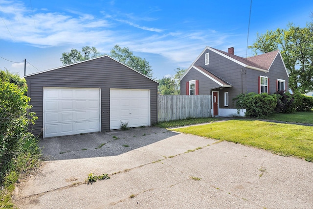 1386 W Broadway Ave, Muskegon, MI 49441 - view of front facade featuring a garage, an outbuilding, and a chimney