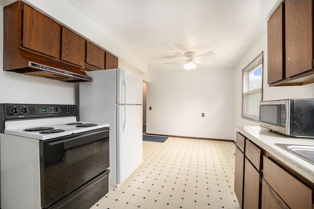6390 Celery St, Kalamazoo, MI 49048 - kitchen with electric range oven, stainless steel microwave, light floors, ceiling fan, and under cabinet range hood