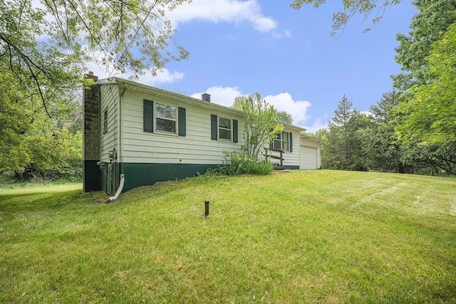 6390 Celery St, Kalamazoo, MI 49048 - back of property featuring a chimney, a yard, and a garage