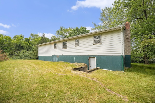 6390 Celery St, Kalamazoo, MI 49048 - back of house featuring a chimney and a lawn