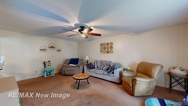 3257 N Christy Way, Saginaw, MI 48603 - living room featuring a ceiling fan, carpet floors, baseboards, and a textured ceiling
