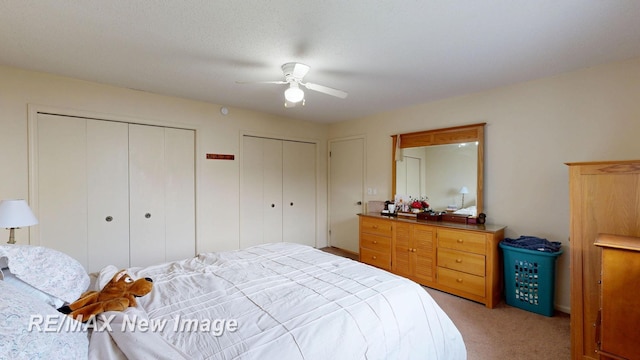 3257 N Christy Way, Saginaw, MI 48603 - bedroom featuring two closets, light colored carpet, and a ceiling fan