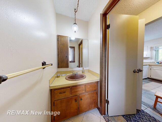 3257 N Christy Way, Saginaw, MI 48603 - bathroom with vanity, a textured ceiling, tile patterned flooring, and lofted ceiling