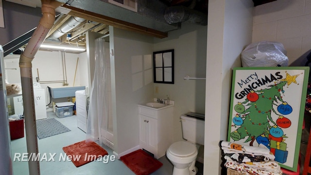 3257 N Christy Way, Saginaw, MI 48603 - bathroom with toilet, a shower with curtain, vanity, finished concrete floors, and washer / clothes dryer