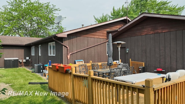 3257 N Christy Way, Saginaw, MI 48603 - rear view of property with outdoor dining area, cooling unit, a deck, and a lawn