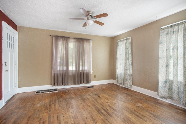 1767 W Michigan Ave, Battle Creek, MI 49037 - unfurnished room featuring a ceiling fan, hardwood / wood-style flooring, a textured ceiling, baseboards, and a textured wall
