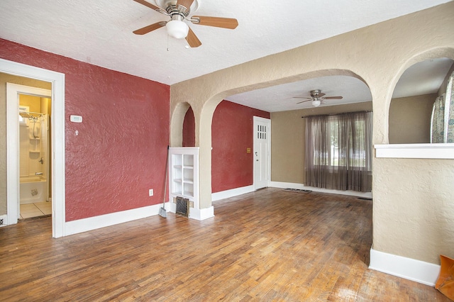 1767 W Michigan Ave, Battle Creek, MI 49037 - unfurnished room featuring a textured wall, ceiling fan, wood finished floors, a textured ceiling, and baseboards