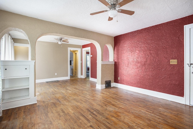 1767 W Michigan Ave, Battle Creek, MI 49037 - spare room featuring ceiling fan, a textured wall, wood finished floors, a textured ceiling, and baseboards