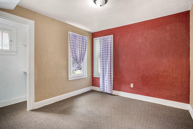 1767 W Michigan Ave, Battle Creek, MI 49037 - carpeted empty room featuring a textured wall and baseboards