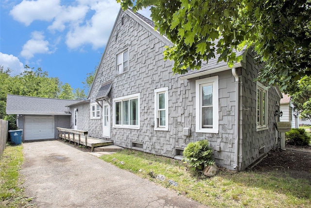 1767 W Michigan Ave, Battle Creek, MI 49037 - view of front facade featuring asphalt driveway, an attached garage, and a wooden deck