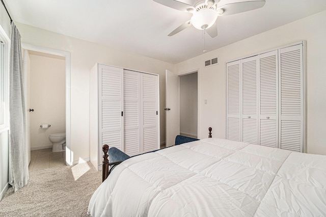 2149 Fair St, Ann Arbor, MI 48103 - carpeted bedroom featuring multiple closets, a ceiling fan, ensuite bathroom, and baseboards