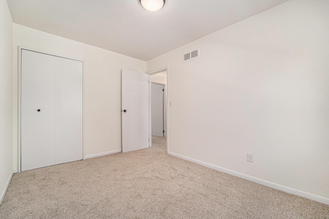 2149 Fair St, Ann Arbor, MI 48103 - unfurnished bedroom with light colored carpet, baseboards, and a closet