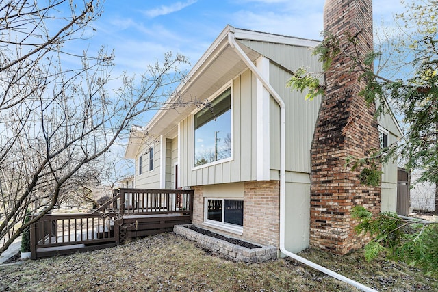 2149 Fair St, Ann Arbor, MI 48103 - view of side of home with a deck, brick siding, and a chimney