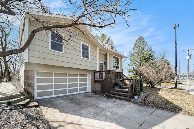 2149 Fair St, Ann Arbor, MI 48103 - view of front of house with an attached garage, driveway, a chimney, and brick siding