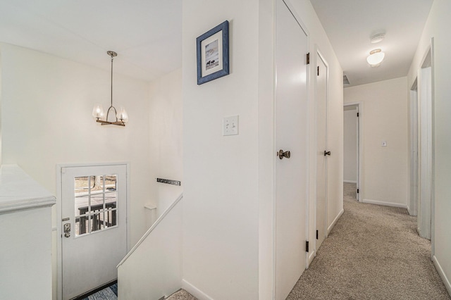 2149 Fair St, Ann Arbor, MI 48103 - hallway featuring carpet, a chandelier, an upstairs landing, and baseboards