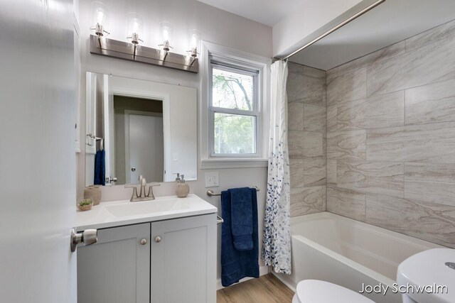 6449 Wendell St SE, Grand Rapids, MI 49546 - bathroom featuring vanity, shower / tub combo with curtain, and wood finished floors