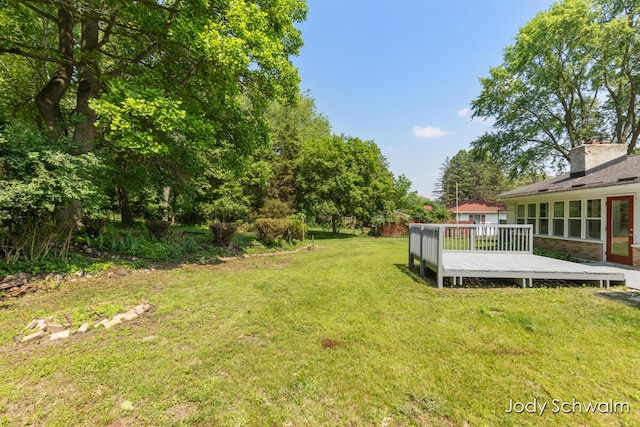 6449 Wendell St SE, Grand Rapids, MI 49546 - view of grassy yard with a wooden deck