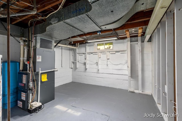 6449 Wendell St SE, Grand Rapids, MI 49546 - basement with concrete block wall, heating unit, and a water pressure tank