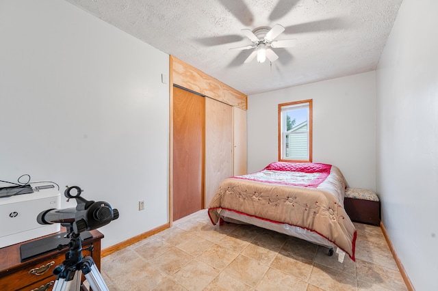20550 19 Mile Rd, Big Rapids, MI 49307 - bedroom featuring a textured ceiling, baseboards, a closet, and ceiling fan
