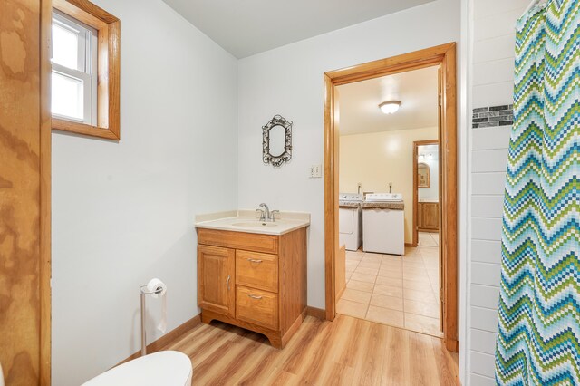 20550 19 Mile Rd, Big Rapids, MI 49307 - full bathroom featuring washer / clothes dryer, vanity, wood finished floors, and toilet
