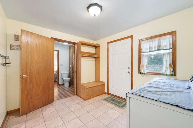 20550 19 Mile Rd, Big Rapids, MI 49307 - bedroom with light tile patterned flooring, a closet, and ensuite bathroom