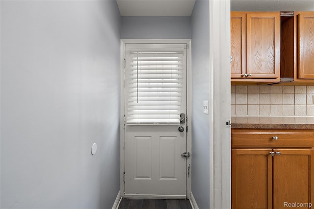 5115 Arden Ave, Warren, MI 48092 - doorway to outside with baseboards and dark wood-type flooring