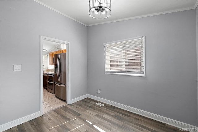 5115 Arden Ave, Warren, MI 48092 - unfurnished room with ornamental molding, baseboards, wood finished floors, a sink, and a chandelier