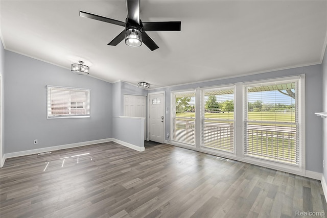 5115 Arden Ave, Warren, MI 48092 - unfurnished room featuring crown molding, healthy amount of natural light, baseboards, wood finished floors, and a ceiling fan