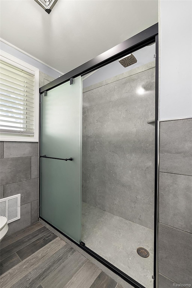5115 Arden Ave, Warren, MI 48092 - full bath featuring a stall shower, wood finished floors, and toilet