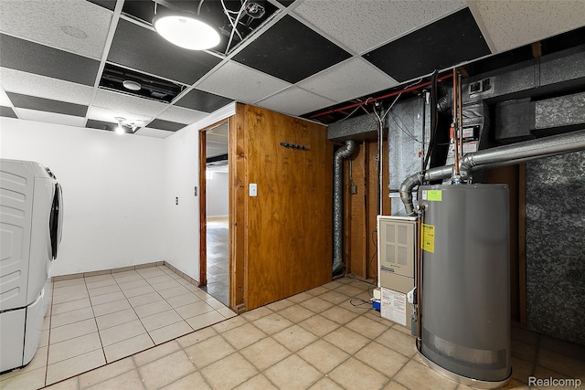 5115 Arden Ave, Warren, MI 48092 - below grade area featuring gas water heater, a drop ceiling, washer / dryer, and light tile patterned flooring