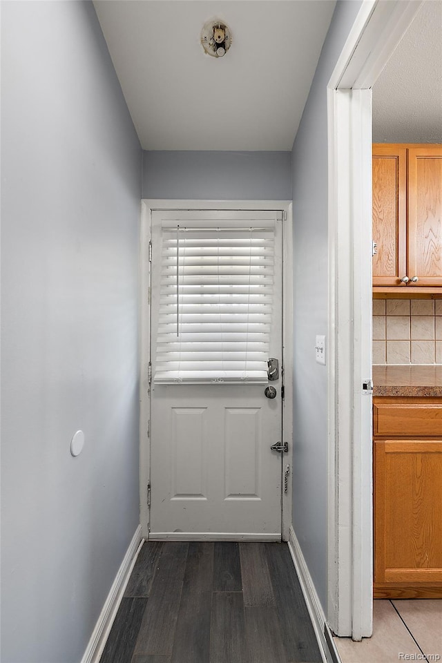 5115 Arden Ave, Warren, MI 48092 - doorway with baseboards and dark wood finished floors
