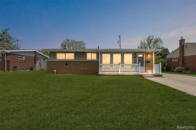 5115 Arden Ave, Warren, MI 48092 - ranch-style home with brick siding, a yard, and a porch