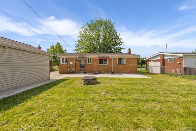 5115 Arden Ave, Warren, MI 48092 - back of house featuring a fire pit, a patio, brick siding, and a chimney