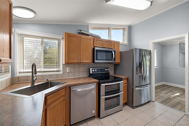 5115 Arden Ave, Warren, MI 48092 - kitchen featuring stainless steel appliances, a sink, ornamental molding, backsplash, and healthy amount of natural light