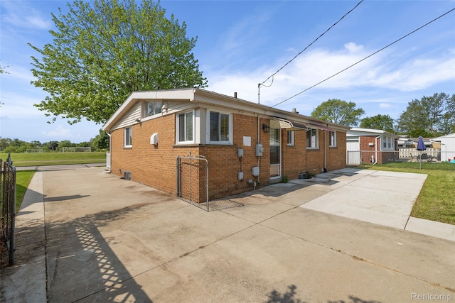 5115 Arden Ave, Warren, MI 48092 - bungalow featuring brick siding, concrete driveway, and a patio