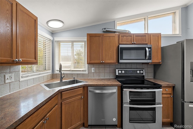5115 Arden Ave, Warren, MI 48092 - kitchen featuring appliances with stainless steel finishes, a sink, crown molding, decorative backsplash, and brown cabinets