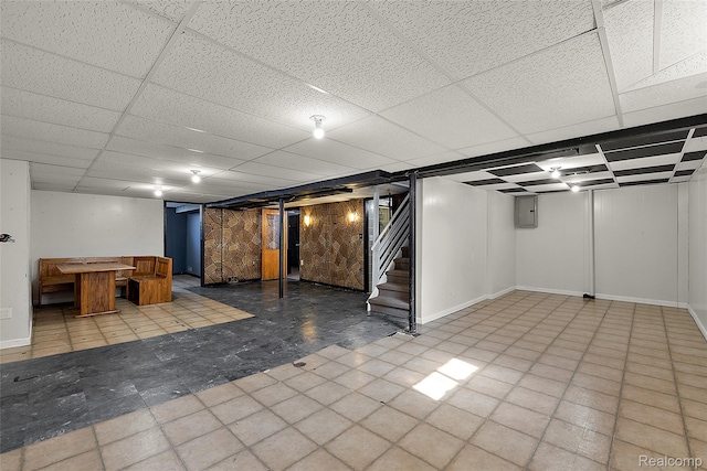 5115 Arden Ave, Warren, MI 48092 - finished basement with a paneled ceiling, stairs, baseboards, and electric panel