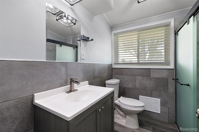 5115 Arden Ave, Warren, MI 48092 - bathroom with tile walls, vanity, toilet, and an enclosed shower