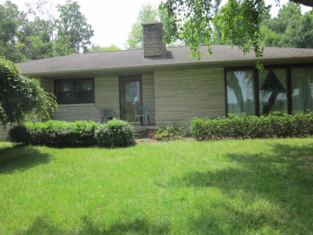 43859 60th Ave, Paw Paw, MI 49079 - view of front facade featuring a front lawn, a chimney, and stone siding