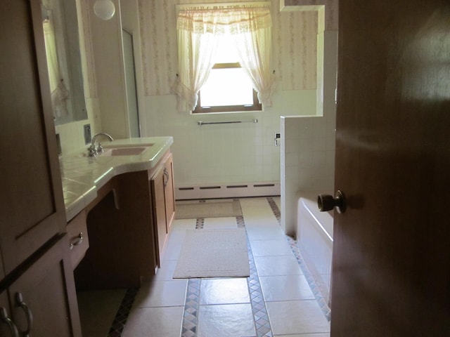 43859 60th Ave, Paw Paw, MI 49079 - bathroom with a baseboard radiator, vanity, a bath, tile patterned flooring, and tile walls