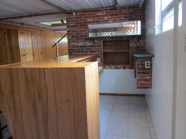 43859 60th Ave, Paw Paw, MI 49079 - bar area with wooden walls and light tile patterned floors