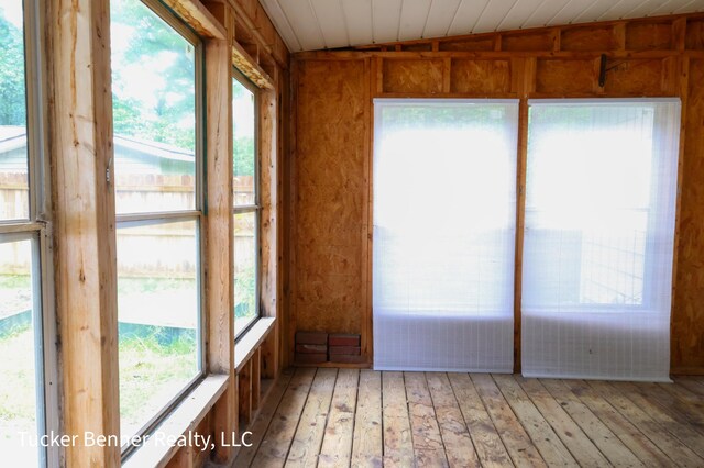 2465 James Ave, Muskegon, MI 49442 - unfurnished sunroom featuring wood-type flooring, healthy amount of natural light, and lofted ceiling