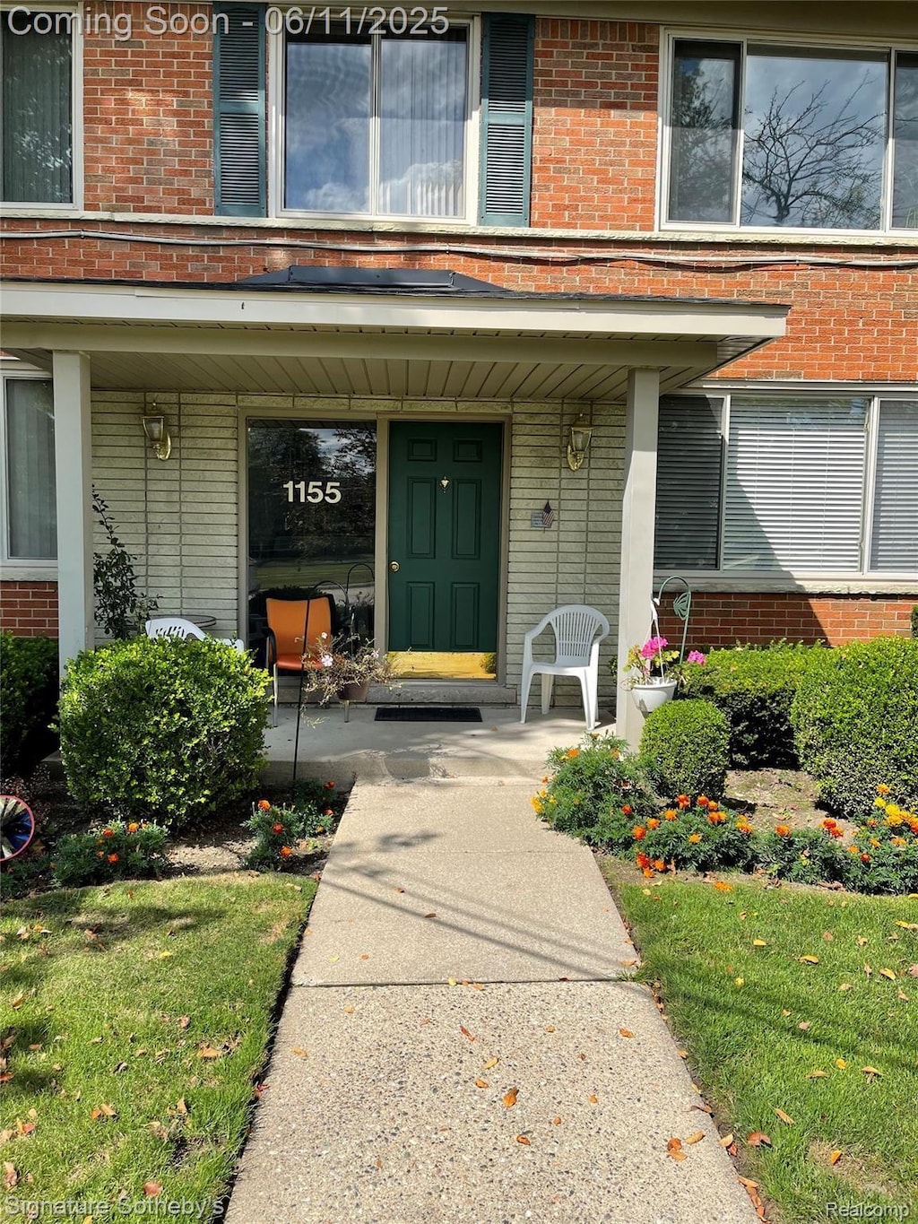 1155 Derby Rd Unit 8, Birmingham, MI 48009 - view of exterior entry with brick siding and a porch
