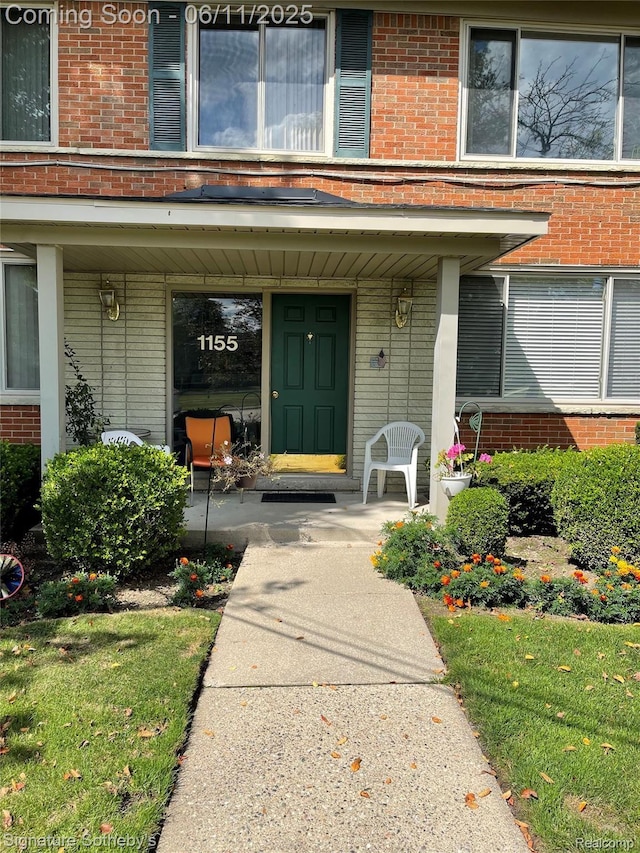 1155 Derby Rd Unit 8, Birmingham, MI 48009 - view of exterior entry with brick siding and a porch