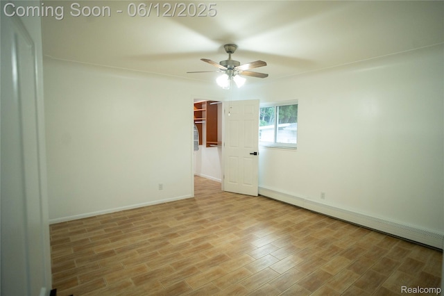 626 Wilwood Rd, Rochester Hills, MI 48309 - spare room featuring a baseboard radiator, ceiling fan, wood finished floors, and baseboards