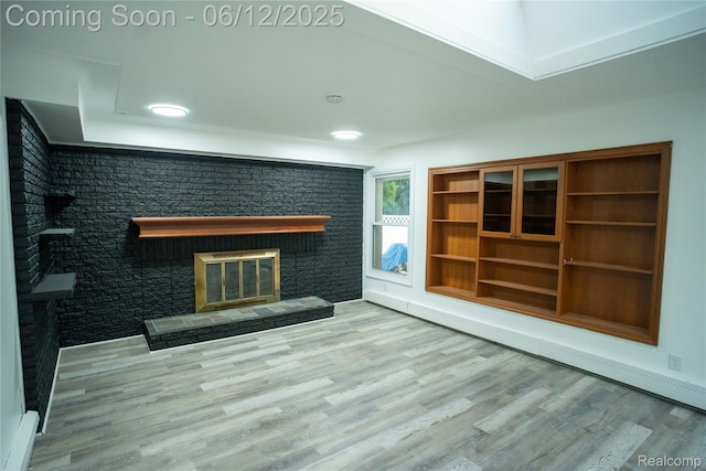 626 Wilwood Rd, Rochester Hills, MI 48309 - unfurnished living room with a brick fireplace, a baseboard radiator, wood finished floors, and recessed lighting