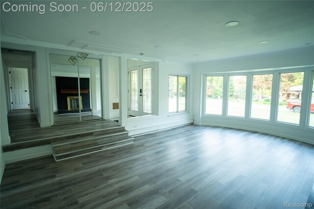626 Wilwood Rd, Rochester Hills, MI 48309 - unfurnished living room with plenty of natural light, wood finished floors, and a fireplace with raised hearth