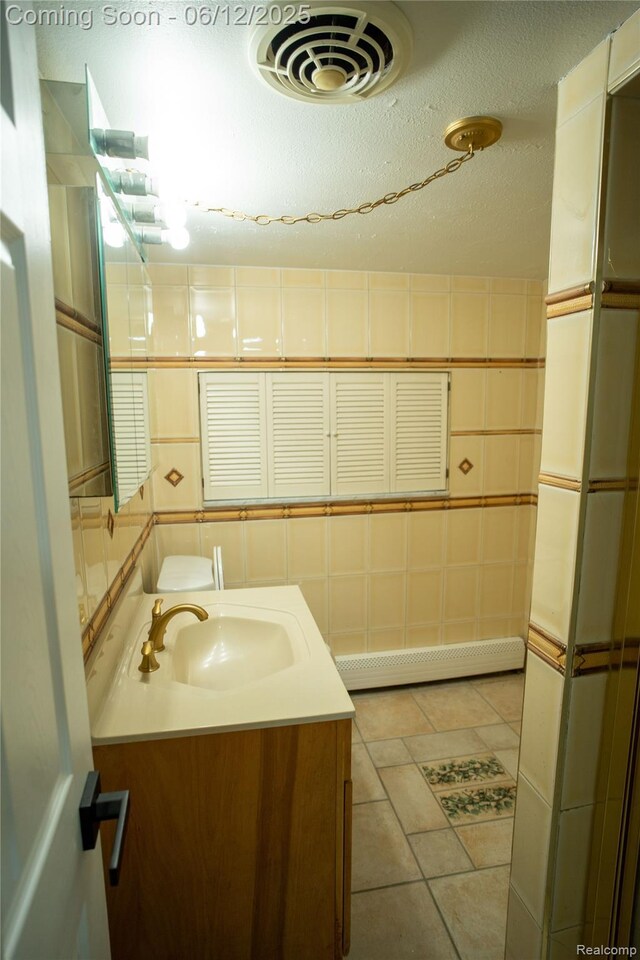 626 Wilwood Rd, Rochester Hills, MI 48309 - bathroom with vanity, baseboard heating, and tile patterned floors
